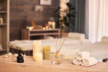 Image showing Spa room, candles and hotel background for massage, aromatherapy and self care holiday or vacation. Bokeh, interior and skincare salon with table, furniture and healing tools or fragrance product