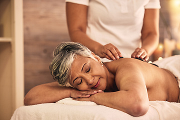 Image showing Woman, spa and stone massage for healing back muscle, skincare treatment and holistic therapy at beauty salon. Mature female person relax at wellness resort with rocks for self care, detox and zen