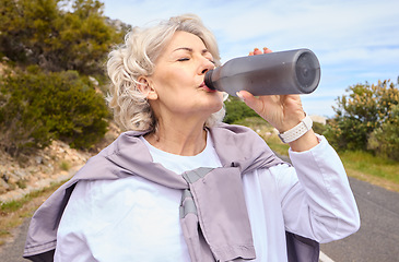 Image showing Elderly woman, drinking water and bottle on road for fitness, running or thinking for vision, hydration or health. Mature lady, runner and detox with relax for wellness, exercise or workout in nature