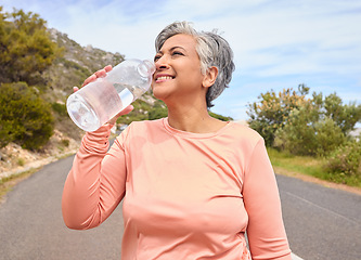 Image showing Senior woman, drinking water and bottle on road for fitness, running and thinking of goal, hydration or health. Mature lady, runner and detox with smile for wellness, exercise or workout in nature