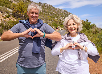 Image showing Senior couple, heart hands and fitness outdoor on road, love icon and portrait with smile, workout or health. Mature woman, man and happy with sign, emoji or symbol for exercise in retirement on hill