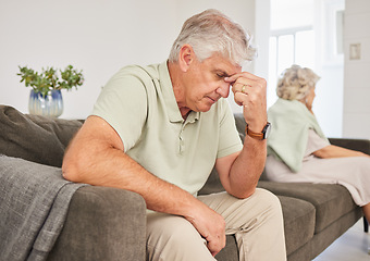 Image showing Senior man, fight and stress of divorce, breakup and headache for argument on sofa. Frustrated, sad and emotional couple in conflict, crisis and problem of drama, bad marriage or anxiety at home