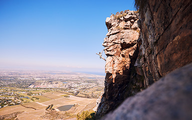 Image showing Sports, rock climbing and space with man on mountain for fitness, adventure and challenge. Fearless, workout and hiking with person on training cliff for travel, freedom and exercise mockup