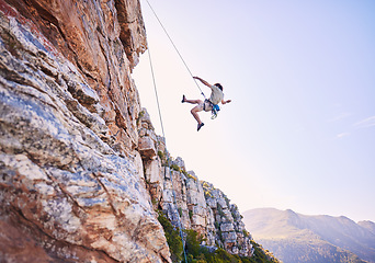 Image showing Rock climbing, jump and mountains with man in nature for sports, explore and adventure. Space, exercise and travel with person training on cliff for rope, challenge and performance mockup