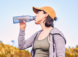 Image showing Break, fitness and woman drinking water in nature for wellness, health and after training. Hydration, rest and an athlete with a bottle to drink after running, hiking or cardio on the mountain