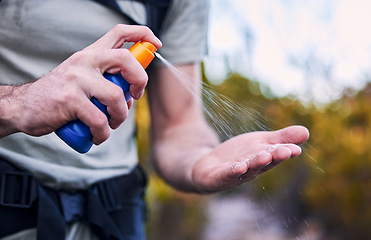 Image showing Sunscreen spray, hand and closeup while hiking for security from the sun and health in summer. Exercise, nature and a man with a bottle with cream for skincare and safety from sunshine for fitness