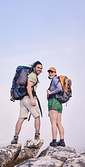 Image showing Mountain, hiking and portrait of man with woman on peak for adventure in nature, rock climbing and travel. Outdoor trekking, happy couple on cliff and relax in mockup space for journey with backpack.