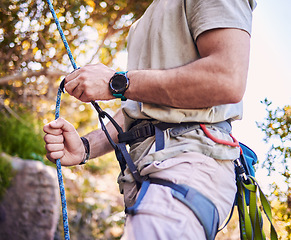 Image showing Rock climbing, mountain and man with rope and harness for adventure, freedom and extreme sports in nature. Fitness, hiking and male person with equipment or gear for training, activity and challenge