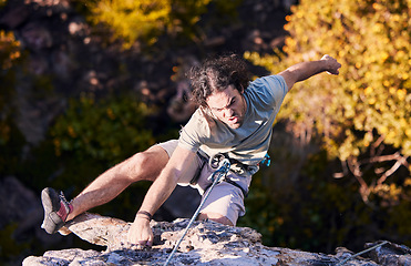 Image showing Adventure, grab and sports, man rock climbing on mountain with cable for support and safety. Extreme workout, challenge and courage, climber on cliff with rope, commitment and fitness in nature.