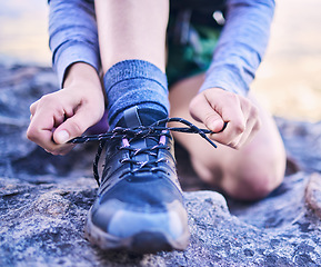 Image showing Shoes, tying laces and a person for fitness, mountain hiking or start training for sports. Nature, exercise and closeup hands of an athlete with feet and ready for running, workout or cardio