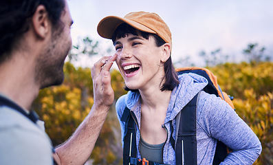 Image showing Hiking, sunscreen and happy couple on mountain for adventure, holiday and journey in nature. Travel, dating and man and woman laughing with spf cream to explore, trekking and backpacking outdoors
