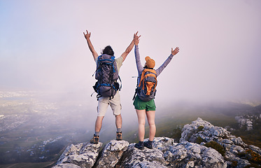 Image showing Mountain, hiking achievement and couple from back on adventure in nature, landscape and travel. Outdoor trekking, man with woman on cliff and relax in view of clouds, natural journey and winning.