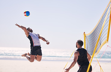 Image showing Beach, volleyball serve and team with competition at ocean and sea with exercise, sport and fitness. Summer, outdoor and training people playing for health, action game and workout activity in nature