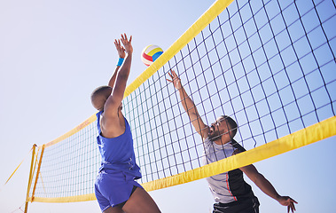 Image showing Jump, hit and beach, volleyball and men at net with sports action, fun and summer competition with blue sky. Energy, ocean games and volley challenge with athlete hitting ball for goal in nature.