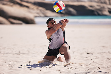 Image showing Beach, volleyball and athlete in action for a match while jumping on the sand on tropical weekend trip. Fitness, sports and young man training or playing a seaside game or tournament by the ocean.