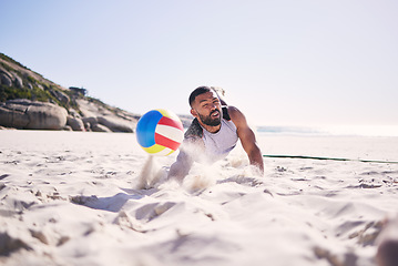 Image showing Fitness, beach or man diving for volleyball in competition, match or sports contest playing on sand. Workout, training or athlete jumping to hit ball at sea for summer game, activity motion or action