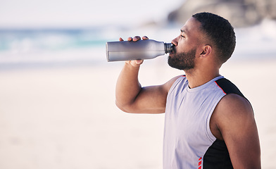 Image showing Beach, fitness and man drinking water after running, workout or cardio exercise on mockup space. Hydration, drink and thirsty male runner with bottle at the sea for training, wellness or sports