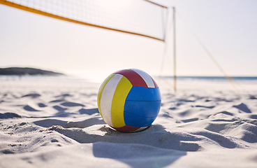 Image showing Beach, volleyball and sand with background of ocean and sea with exercise, sport and fitness equipment. Summer, outdoor and training ball on the ground for health, game and workout activity in nature