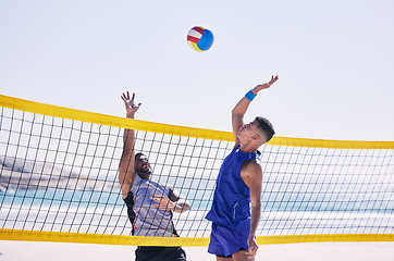 Image showing Beach, volleyball and men at net with sports action, fun and summer competition with motivation to win. Energy, ocean games and volley challenge with team hitting ball for goal at workout in nature.