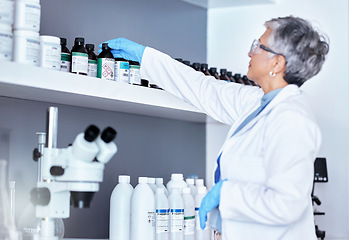 Image showing Research, medical and a scientist with a chemical in a lab for healthcare innovation or analytics. Science, expert and a mature woman with medicine, working on pharmaceutical test and inspection