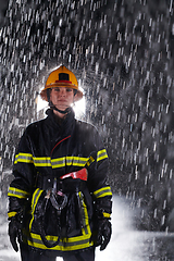 Image showing A determined female firefighter in a professional uniform striding through the dangerous, rainy night on a daring rescue mission, showcasing her unwavering bravery and commitment to saving lives.