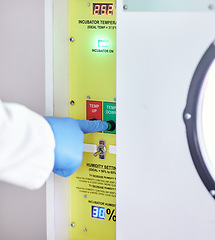 Image showing Laboratory, temperature and hands on button on machine for science research, experiment or test. Lab, scientist hand with glove and exam safety in technology for medical engineering and manufacturing