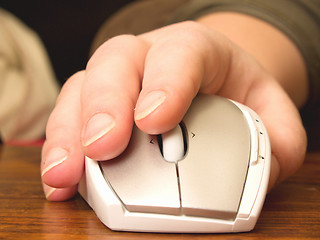 Image showing Business concept - Hand using computer mouse on wooden table