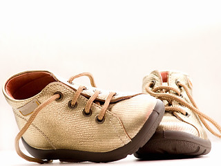 Image showing Trendy little golden baby shoes  with copyspace