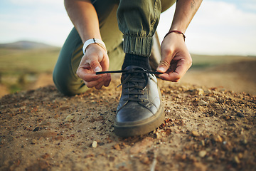 Image showing Hands, tie shoes and hiking in nature for travel, training or adventure outdoor. Fitness, sports and person tying laces on sneakers to start workout, walk or running, cardio or workout in countryside