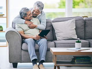 Image showing Tablet, couple and hug on sofa in home living room for love, care and quality time. Senior man, happy woman and embrace with digital technology for online shopping, social media and scroll internet