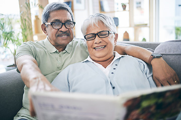 Image showing Couple, talking and reading book together on sofa in living room with love, relax and quality time. Senior man, happy woman or partner with glasses, discussion or books on couch at home in retirement