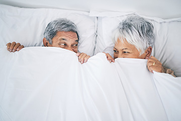 Image showing Bed, funny and senior couple covering with a blanket in a bedroom bonding as happiness and playing to enjoy retirement. Happy, goofy and elderly people, man and woman with trust in marriage in a home