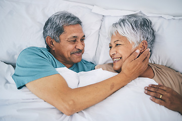 Image showing Bed, love and happy senior couple in a bedroom bonding as care, support and relax to enjoy retirement in a home. Smile, solidarity and elderly people, man and woman with trust in marriage together