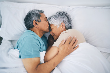 Image showing Top view, hug and senior couple in bed, love and sleeping with retirement, wake up or happiness with a kiss. Romance, old man or elderly woman embrace, bedroom or holiday with marriage or loving