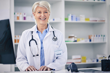 Image showing Happy, portrait and a pharmacist typing on a computer for medical information, email or working. Smile, pharmacy and a mature woman with a pc at a clinic or medicine store to check for stock