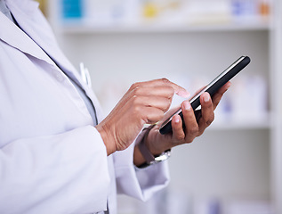Image showing Woman, hands and phone of pharmacist typing in research, communication or online browsing at pharmacy. Closeup of female person, medical or healthcare professional on mobile smartphone app at clinic