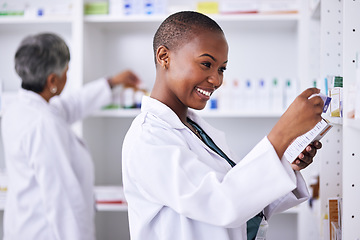 Image showing Happy black woman, pharmacist and pills for inventory inspection or checking stock on shelf at pharmacy. African female person in medical healthcare with pharmaceutical product for medication storage