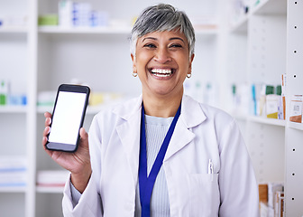 Image showing Portrait, mockup phone and a woman at a pharmacy for medical service, healthcare and showing an app. Smile, contact and a mature pharmacist with a blank mobile screen advertising medicine or advice