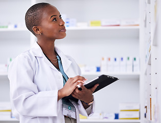 Image showing Black woman, pharmacist and tablet for inventory inspection or checking stock at the pharmacy. African female person in medical healthcare looking at shelf for pharmaceutical checklist on technology
