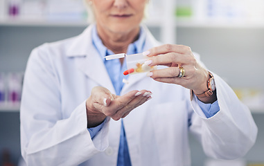 Image showing Pharmacist, hands and pills in pharmacy or closeup with medicine support or cure. Prescription, capsules and health care profession at drug store for treatment for correct dose or medical treatment.