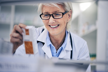 Image showing Happy woman, pharmacist and reading medication on shelf for inventory, diagnosis or prescription at pharmacy. Mature female person, medical or healthcare professional checking medicine in drugstore