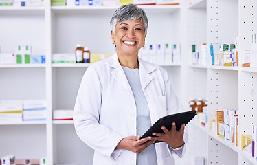 Image showing Happy woman, portrait and pharmacist with tablet for inventory inspection or stock at pharmacy. Mature female person smile in medical or healthcare store for pharmaceutical checklist on technology