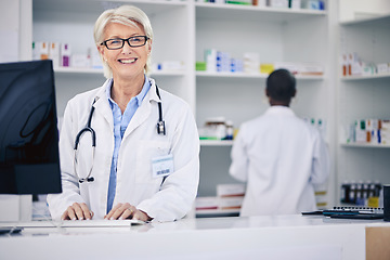 Image showing Pharmacist, portrait and happy senior woman on computer in pharmacy, drugstore or shop. Smile, medical professional and face of doctor on internet for telehealth, healthcare and research for medicine