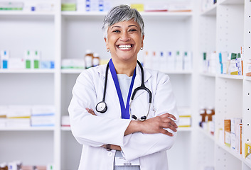 Image showing Senior woman, pharmacist with arms crossed or portrait of doctor in pharmacy, pharmaceutical store or shop for healthcare. Medicine, consultation on health and confident in medical advice on pills