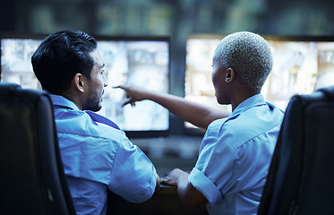 Image showing Security guard in control room, man and woman with screen to check cctv together in team office. Safety, surveillance and teamwork, video to monitor crime and privacy at night for protection service.