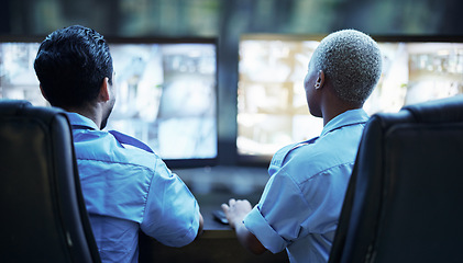 Image showing Security guard in control room, team checking screen of cctv computer together in secret office. Safety, surveillance and teamwork, video to monitor crime and privacy at night for protection service.