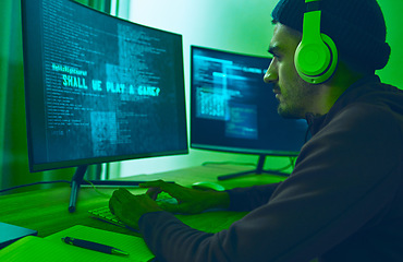 Image showing Cyber, gaming and a man with a computer for hacking, streaming music or working on phishing. Serious, dark and a hacker or gamer with a website or information on a pc for a network or privacy