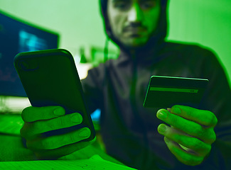 Image showing Man, phone or hacker with credit card for scam, online fraud or cybersecurity crime at night on dark web. Thief, financial or hands of man typing password data or banking info on fintech mobile app