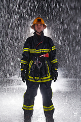 Image showing A determined female firefighter in a professional uniform striding through the dangerous, rainy night on a daring rescue mission, showcasing her unwavering bravery and commitment to saving lives.