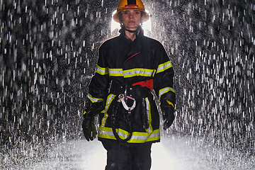 Image showing A determined female firefighter in a professional uniform striding through the dangerous, rainy night on a daring rescue mission, showcasing her unwavering bravery and commitment to saving lives.